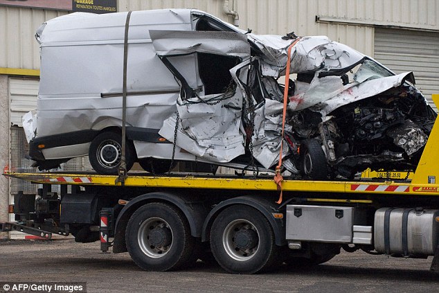 The wreckage of the minibus after it collided with a truck in Moulins in central France late last night