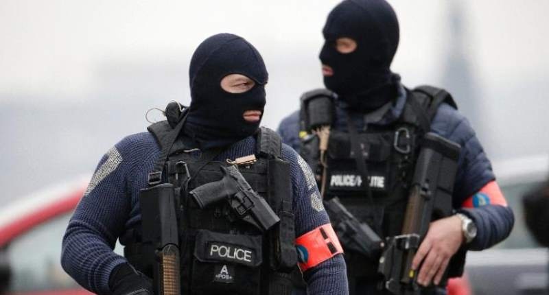 Special police forces stand guard outside the Council Chamber of Brussels