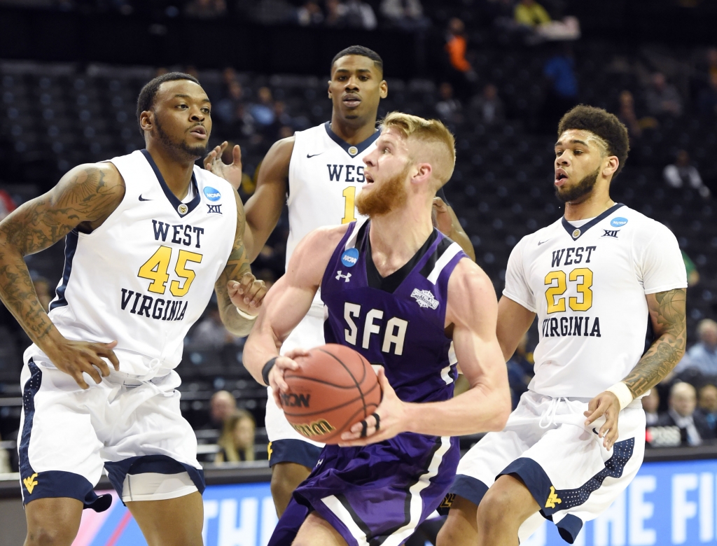 Mar 18 2016 Brooklyn NY USA Stephen F. Austin Lumberjacks forward Thomas Walkup drives to the basket against West Virginia Mountaineers players Elijah Macon  Esa Ahmad and Jonathan Holton in the first half in the first round