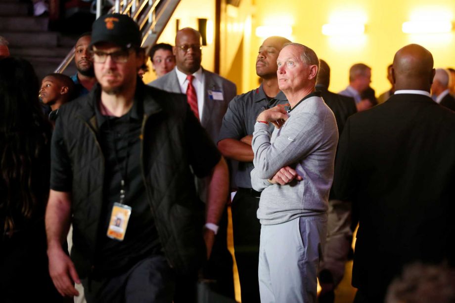 Southern California athletic director Pat Haden center stands near the court after the Galen Center stadium lights unexpectedly turned off during the first half of an NCAA college basketball game between Oregon and Southern California Saturday March 5