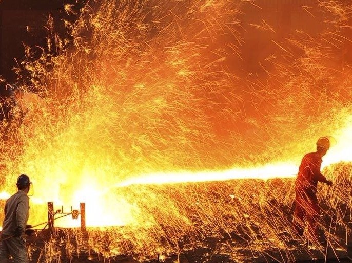 Employees work at a steel factory in Dalian Liaoning province in this