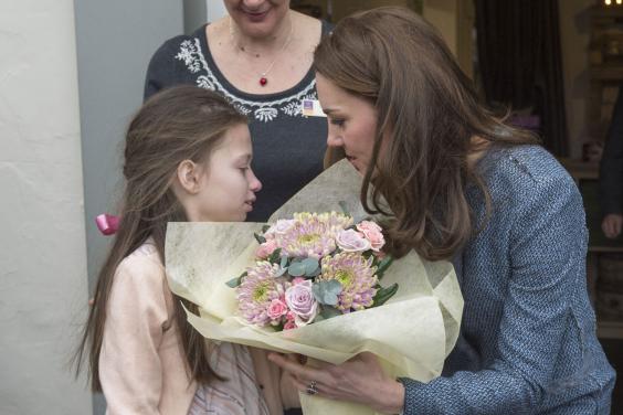 Tour guide The Duchess of Cambridge is given a posy by Rebekah Hughes