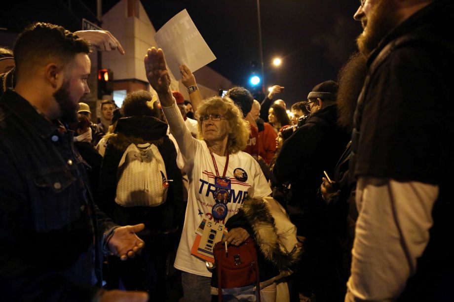 Donald Trump supporter Birgitt Peterson of Yorkville Ill. argues with protesters ﻿Friday outside the UIC Pavilion after Trump's canceled rally in Chicago