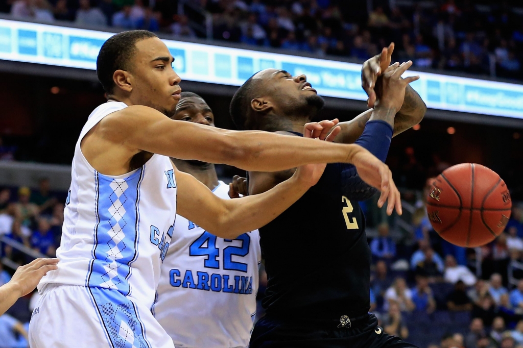 Pitt UNC basketball North Carolina's Brice Johnson left and Joel James center battle for possession with Pitt forward Michael Young during today's ACC tournament game in Washington D.C