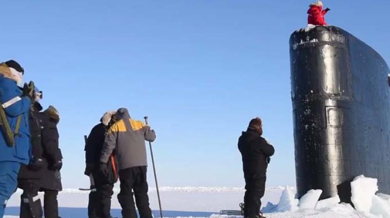 The video shows a black coloured tower-like portion of the submarine breaking the ice and emerging out of