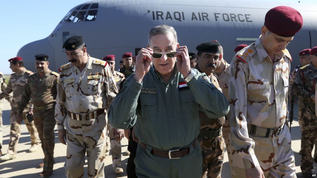 Iraqi Defense Minister Khaled al-Obeidi center arrives at a military a base outside Tikrit 130 kilometers north of Baghdad Iraq