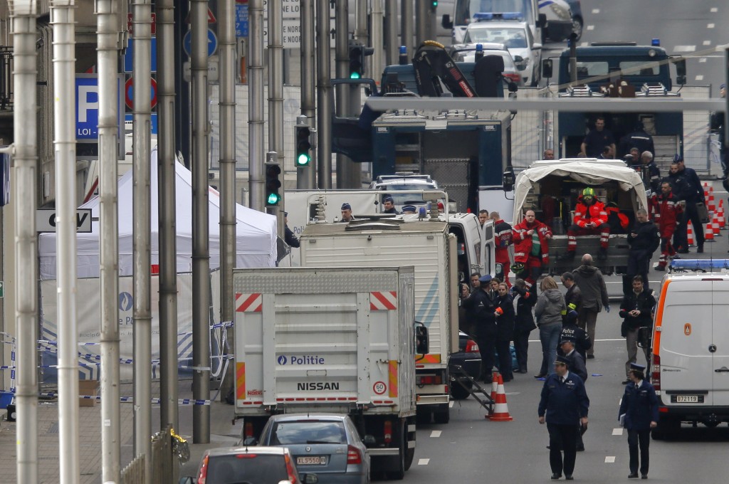 Belgian police and emergency personnel work near the Maalbeek metro station following an explosion in Brussels Belgium