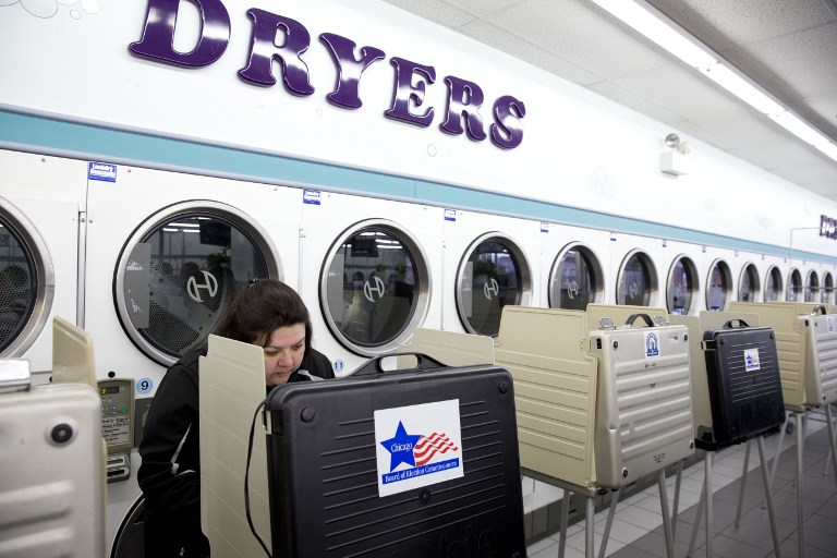 Voters cast ballots in the Illinois primary at Su Nueva Laundromat in West Lawn Chicago