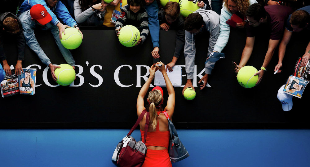 Maria Sharapova of Russia signs autographs after defeating Eugenie Bouchard of Canada in their women's singles quarter-final match at the Australian Open 2015 tennis tournament in Melbourne