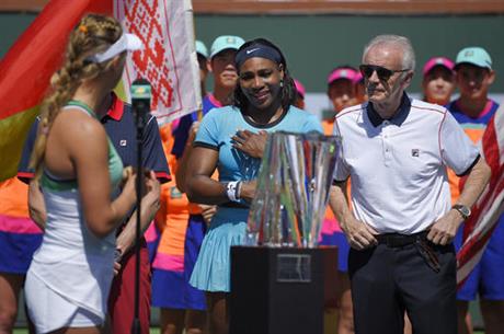 Victoria Azarenka left of Belarus speaks to Serena Williams as tournament director Raymond Moore stand by after Azarenka defeated Williams in a final at the BNP Paribas Open tennis tournament Sunday