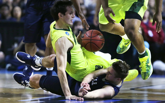 Yale guard Makai Mason hits the floor while chasing the ball as Baylor guard Jake Lindsey falls on him in the second half during the first round