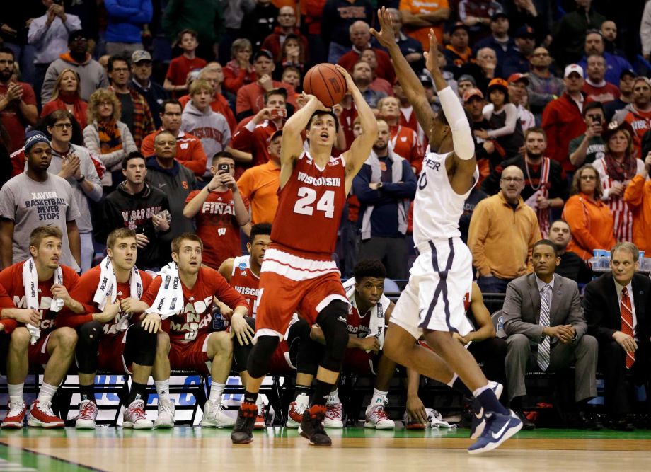 Wisconsin's Bronson Koenig shoots a last second 3-point shot over Xavier's Remy Abell to give Wisconsin a 66-63 victory in a second-round men's college basketball game in the NCAA Tournament Sunday