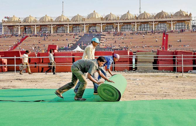 Workers lay astro turf at the AoL event venue on Yamuna floodplains  Sri Sri Ravi Shankar. Pic  PTI