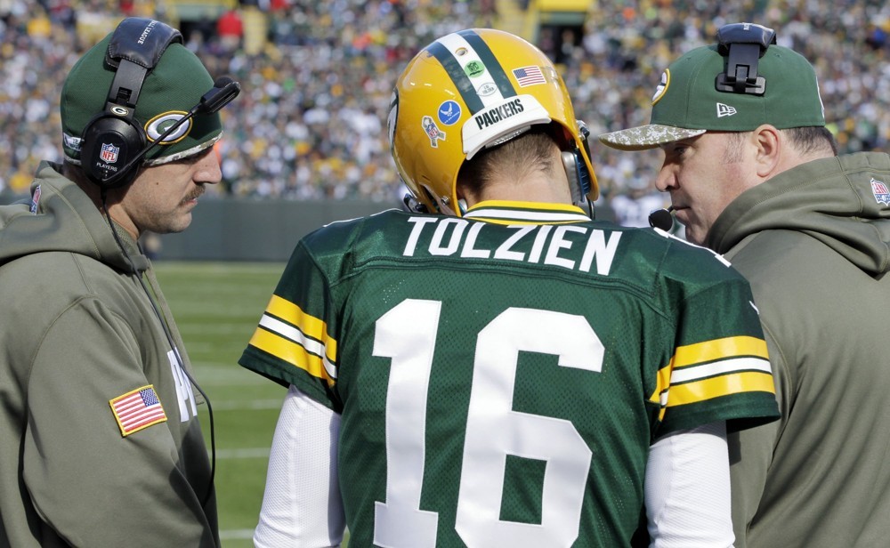 Nov. 10 2013- Green Bay WI USA- Aaron Rodgers of the Green Bay Packers left joins Head Coach Mike McCarthy right and Scott Tolzien during the second quarter of their game against the Philadelphia Eagles at Lambeau Field in Green Bay Wis. on Sun