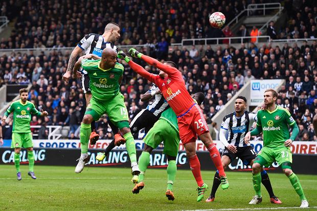 NEWCASTLE UPON TYNE ENGLAND – MARCH 20 Aleksandar Mitrovic of Newcastle United heads past Vito Mannone of Sunderland during the Barclays Premier League match between Newcastle United and Sunderland at St James’ Park