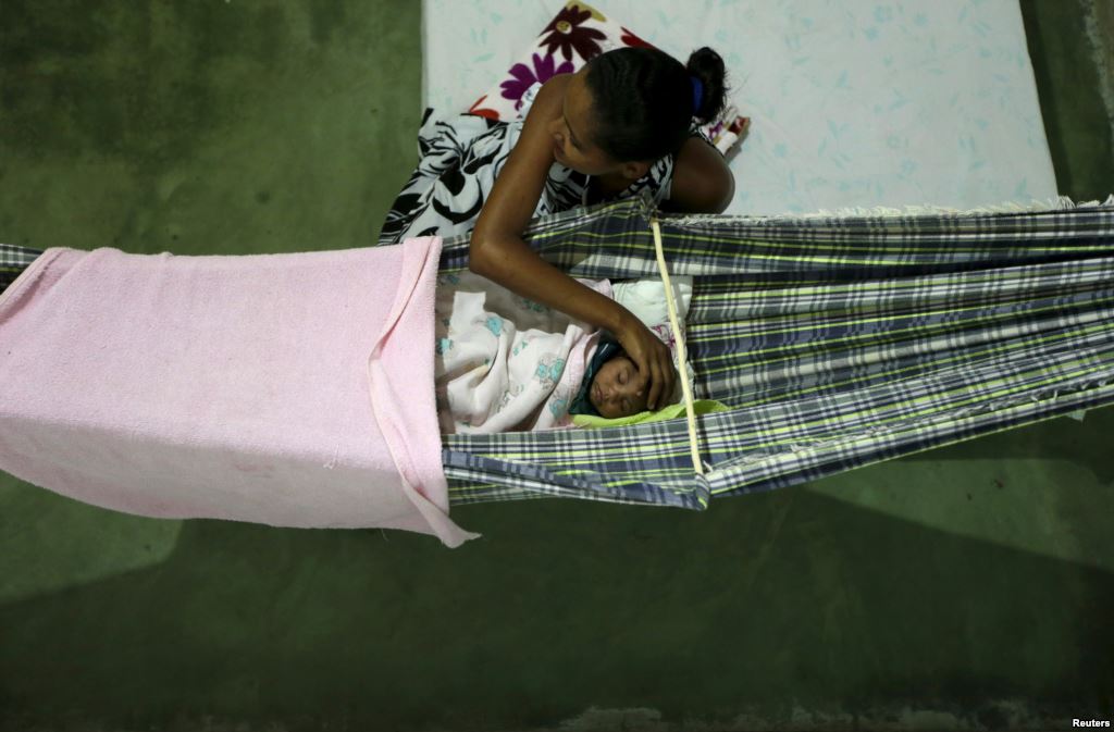 Miriam Araujo 25 caresses Lucas her 4-month-old child born with microcephaly as he sleeps on a hammock inside their house in Sao Jose dos Cordeiros Brazil Feb. 16 2016