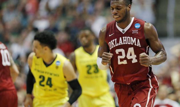 Oklahoma guard Buddy Hield celebrates after scoring during the second half of an NCAA college basketball game against Oregon in the regional finals of the NCAA Tournament Saturday