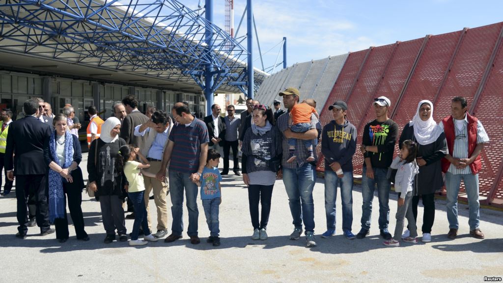 A group of Syrian refugees wait to board a plane with Pope Francis at the airport of Mytilene in the Greek island of Lesbos