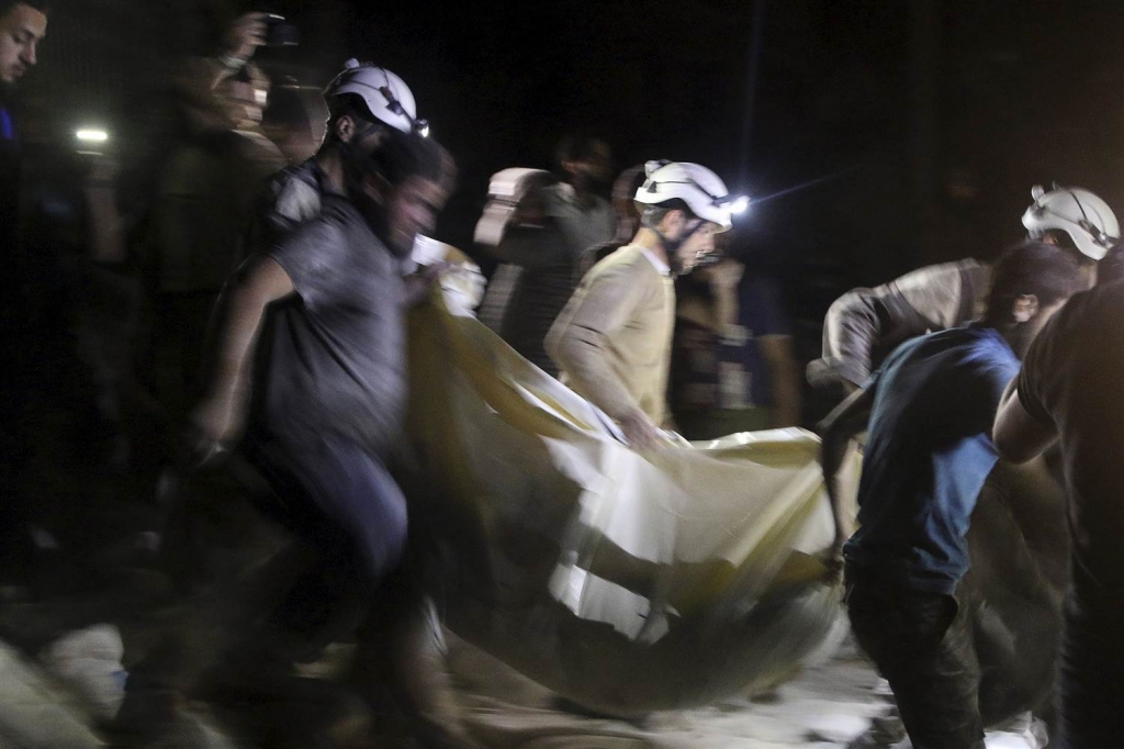 Image A victim is carried from the hospital in Aleppo Syria