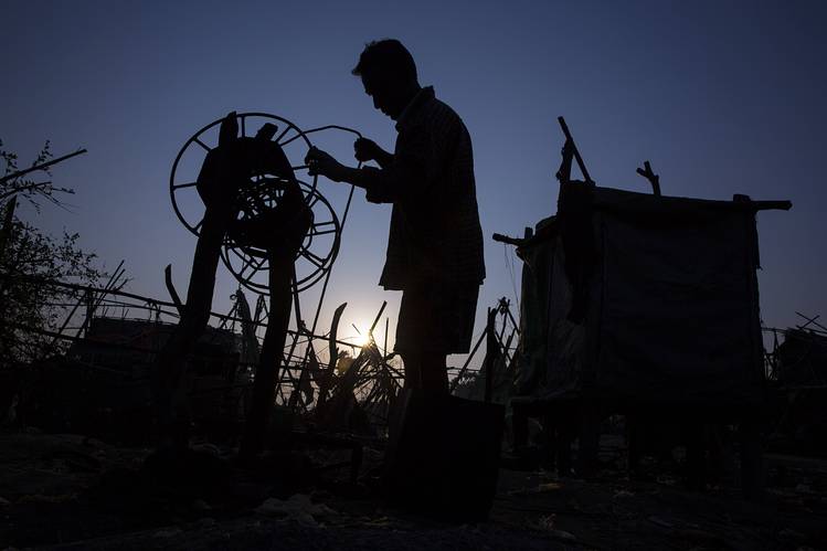 A worker drilling for oil using a hand-powered winch at a field in the Bago region of Myanmar on Feb. 1