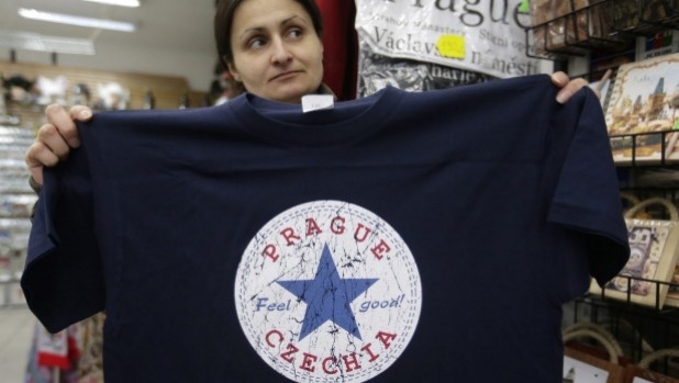 A vendor displays a T-shirt with the word'Czechia in a store in Prague Czech Republic