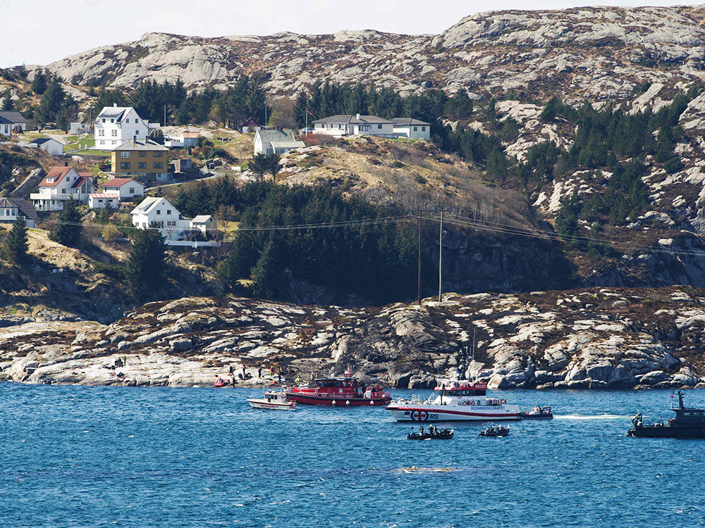 A rescue official says 11 bodies have been found after the crash of a helicopter on an island off the coast of western Norway. Two people are still missing