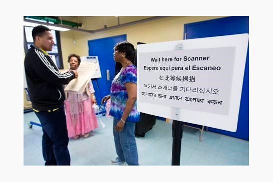 Darling Diaz left talks with poll worker Jamie Williams Rivera before voting in the Flushing neighborhood in the Queens borough of New York Tuesday