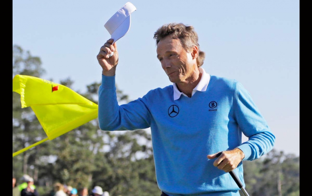 Bernhard Langer of Germany tips his cap after putting out on the 18th hole during the third round of the Masters golf tournament Saturday