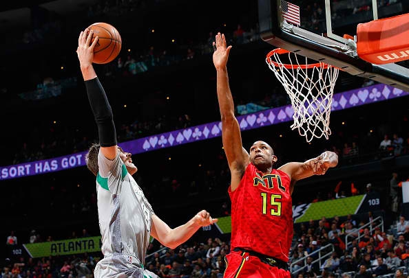 Al Horford of the Atlanta Hawks jumps to block a shot by Jonas Jerebko