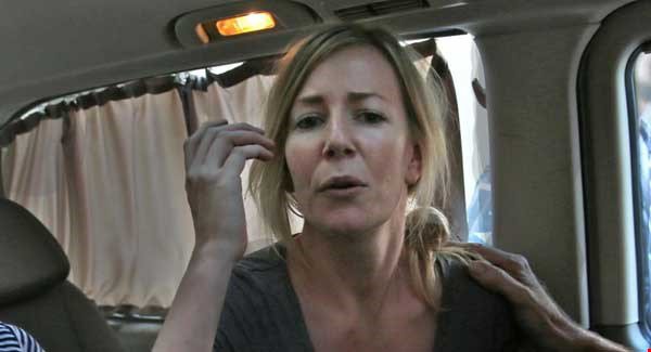 Australian Sally Faulkner the mother of the two Australian children gestures as she sits in a mini van after she was released from jail