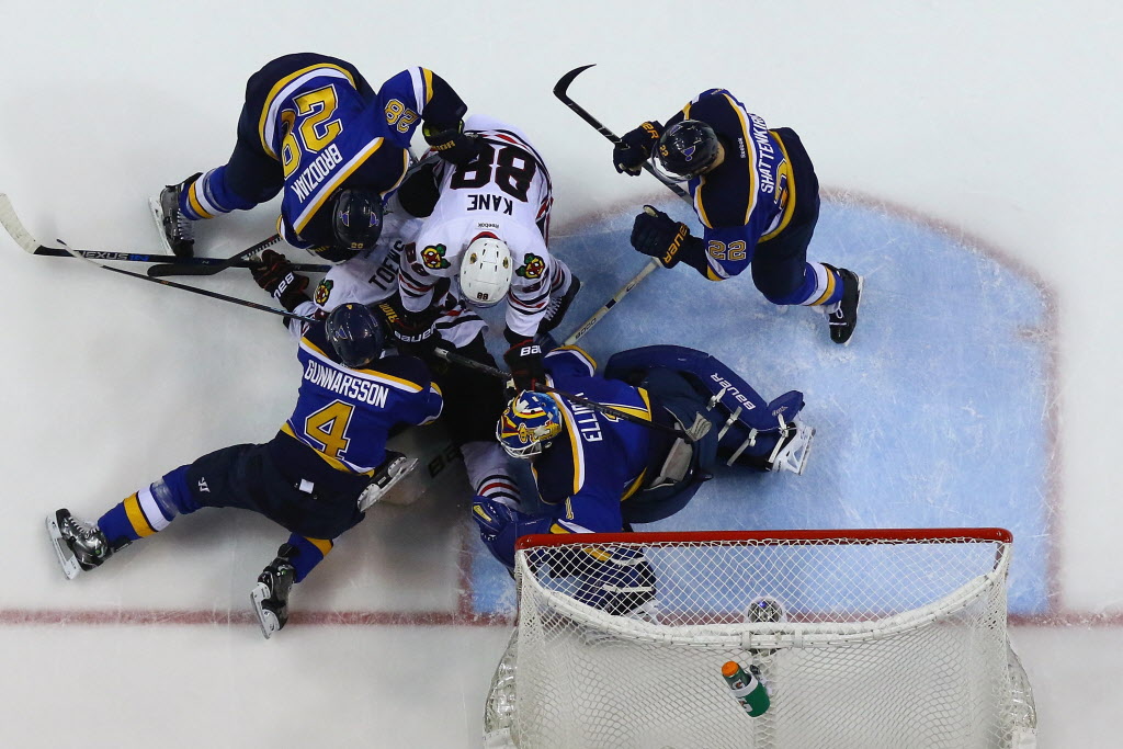 ST. LOUIS MO- APRIL 13 Brian Elliott #1 Kevin Shattenkirk #22 Carl Gunnarsson #4 and Kyle Brodziak #28 of the St. Louis Blues defend the goal against Jonathan Toews #19 and Patrick Kane #88 of the Chicago Blackhawks in Game One of the Western Confer