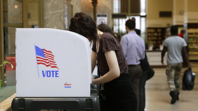 People cast their votes at a polling station inside the Enoch Pratt Free Library's central library branch in Baltimore Tuesday