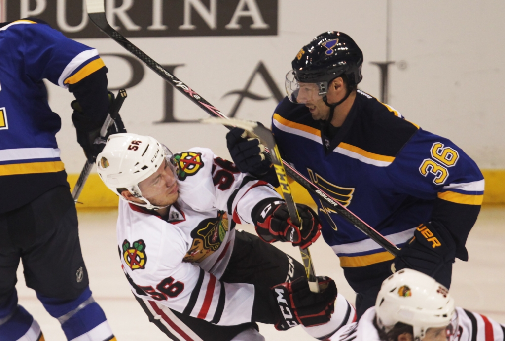 St. Louis Blues Troy Brouwer knocks Chicago Blackhawks Marko Dano to the ice during the first period at the Scottrade Center in St. Louis