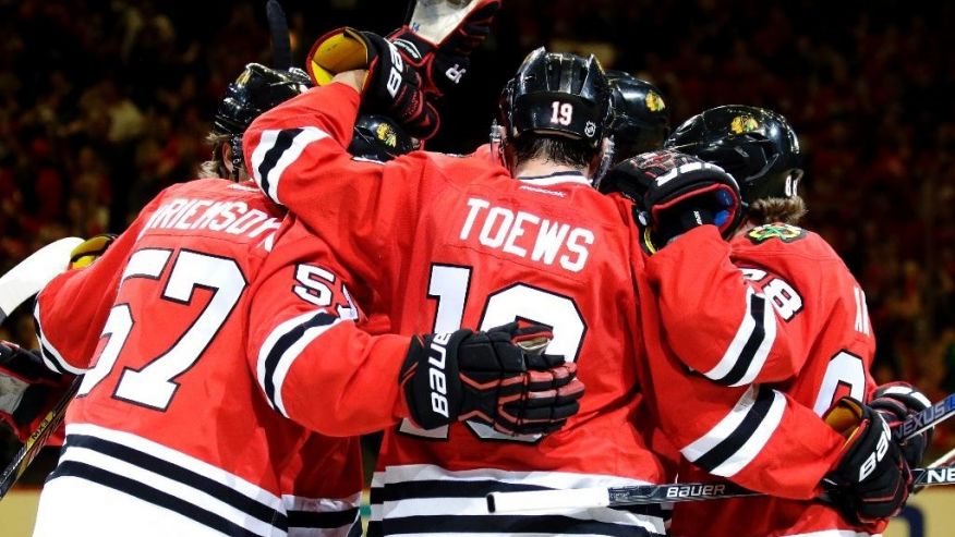 Chicago Blackhawks defenseman Trevor van Riemsdyk celebrates with teammates after scoring a goal against the St. Louis Blues during the second period in Game 6 of an NHL hockey first-round Stanley Cup playoff series Saturday