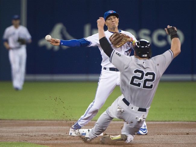 Toronto Blue Jays second baseman Ryan Goins forces out New York Yankees centre fielder Jacoby Ellsbury at second base then turns the double play over to first to out New York Yankees centre fielder Aaron Hicks during first inning AL basebal