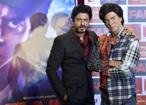 Bollywood actor Shah Rukh Khan poses with a waxwork model of himself at Madame Tussauds in London