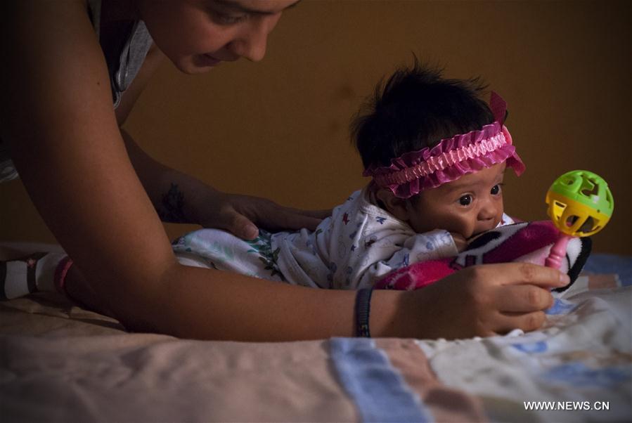 Image taken on Feb. 27 2016 shows Angela Martinez playing with her daughter Dominic Andrade, who suffers microcephaly in Quito capital of Ecuador. Dominic Andrade 4 months old permanently receives therapy at home and on the facilities of a hospi