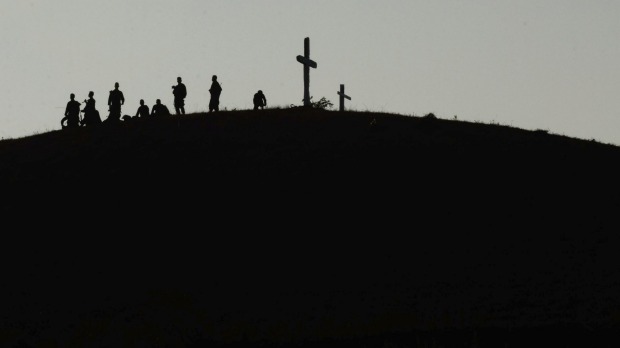 Philippine troops stand guard on a hill at daybreak in Crow Valley Tarlac province Philippines during the 11-day