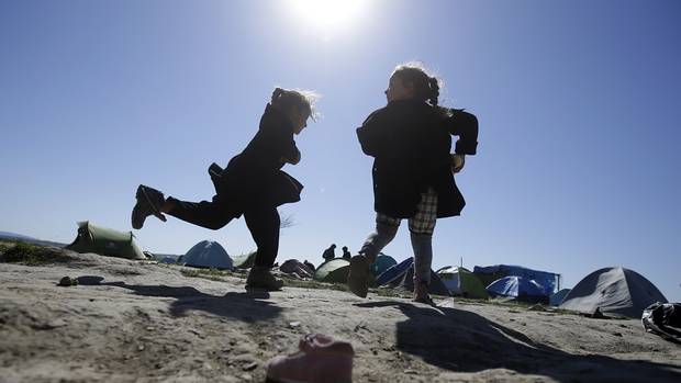 Children play in a makeshift camp at the northern Greek border point of Idomeni