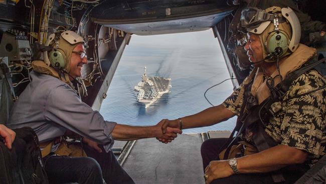 In this image released by the US Department of Defense US Secretary of Defense Ash Carter and Philippine Secretary of National Defense Voltaire Gazmin shake hands on a Marine Corps V-22 Osprey as they depart the USS Stennis after touring the aircraft