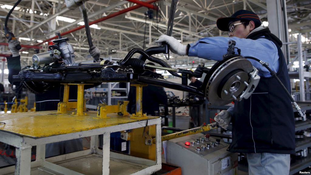 FILE- An employee works on an assembly line producing electronic cars at a factory of Beijing Electric Vehicle funded by BAIC Group in Beijing China Jan. 18 2016