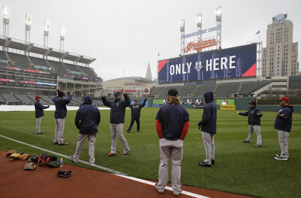 Members of the Boston Red Sox stretch before a baseball game between the Red Sox and the Cleveland Indians Monday