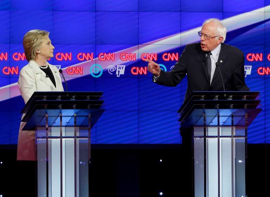 Democratic presidential candidates Sen. Bernie Sanders I-Vt. right and Hillary Clinton speak during the CNN Democratic Presidential Primary Debate at the Brooklyn Navy Yard on Thursday