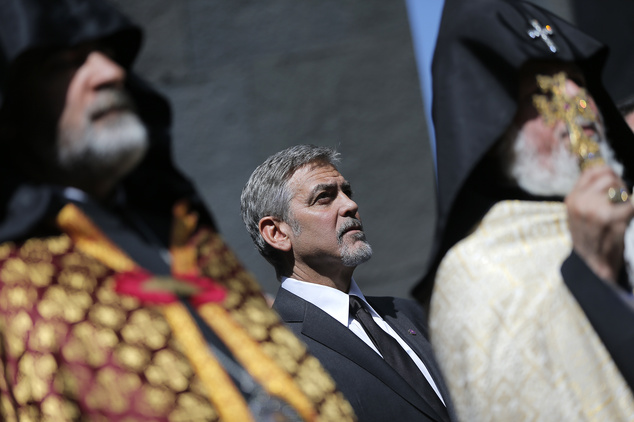 US actor George Clooney center attends a ceremony at a memorial for Armenians killed by the Ottoman Turks in Yerevan Armenia on Sunday