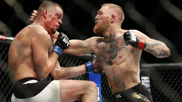 Conor McGregor right trades punches with Nate Diaz during his losing UFC 196 welterweight mixed martial arts match