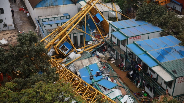 Rescuers work at the accident site of a collapsed temporary structure Thursday on a construction site in Mayong Township of Dongguan City