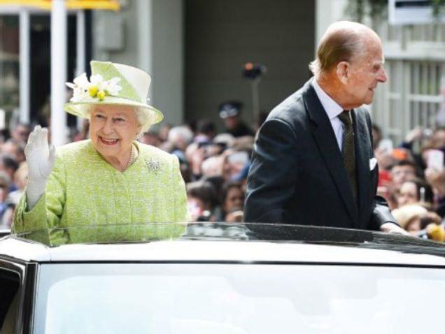 Queen Elizabeth II and Prince Philip Duke of Edinburgh travel through Windsor in an open top Range Rover after her 90th Birthday Walkabout on Thursday in Windsor England. The Queen and Duke of Edinburgh will be carrying out engagements in Windsor