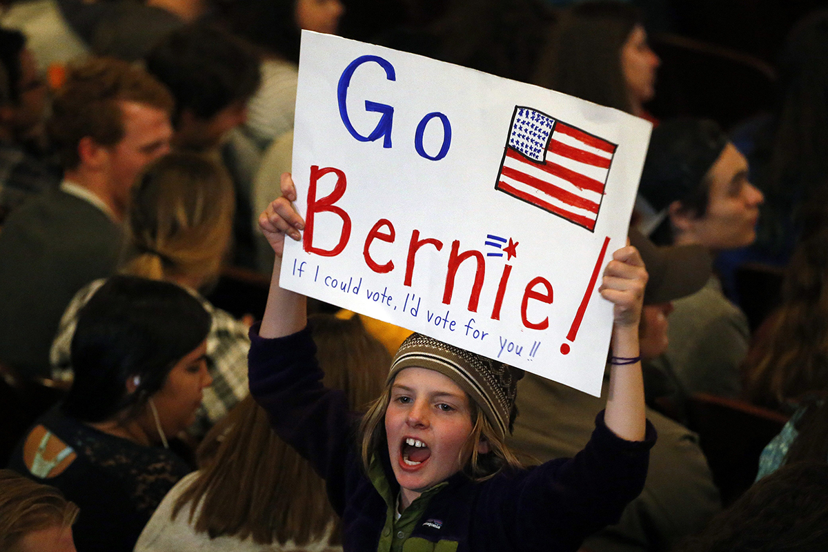 Local 3rd grader Marlow Mittelstaedt holds a sign and cheers while waiting for the arrival of Democratic presidential candidate Sen. Bernie Sanders before a campaign rally in Laramie Wyo. Tuesday