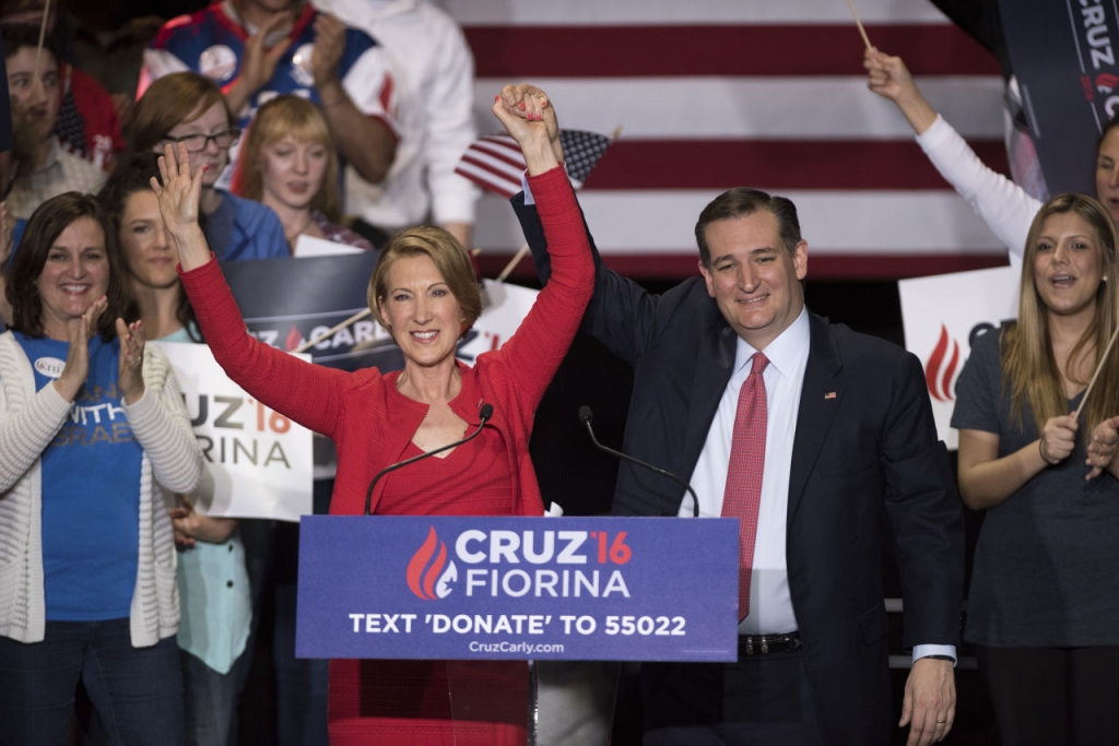 Republican presidential candidate Sen. Ted Cruz holds up hands with former Hewlett Packard chief executive Carly Fiorina at a campaign rally in the Pavilion at the Pan Am Plaza