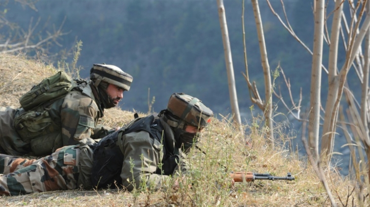 Indian soldiers overlook army barracks after an attack by militants in Gingal Uri some 90 kms north of Srinagar in Jammu and Kashmir